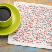 Marketing is about relationships - coffee cup next to brainstorming doodles on napkin